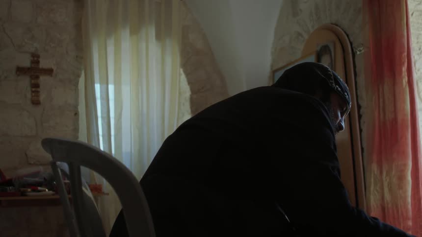 A priest is working in a church
