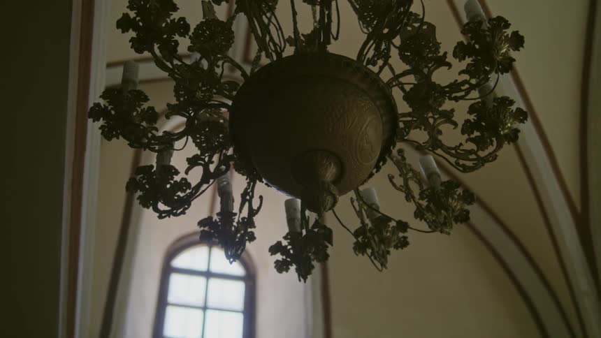 A chandelier with candles hangs overhead