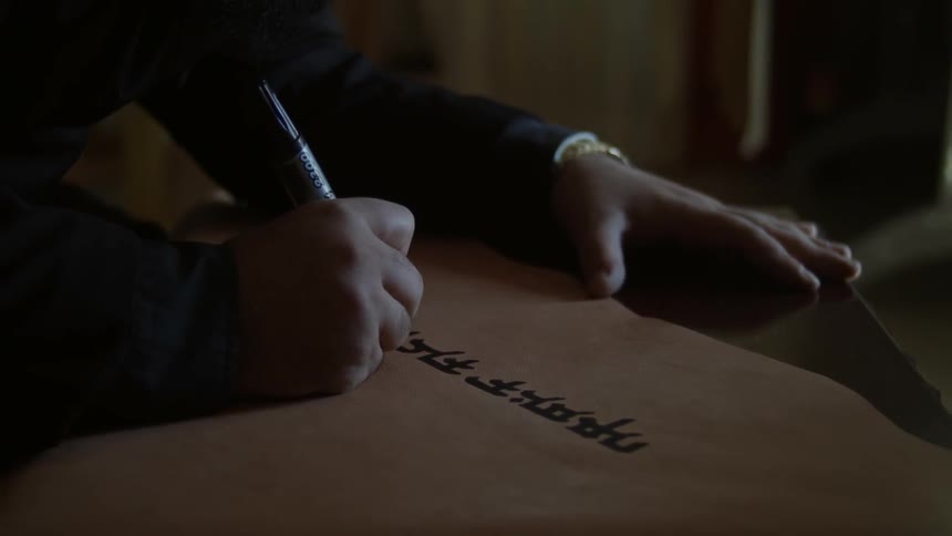 A person is writing with a market