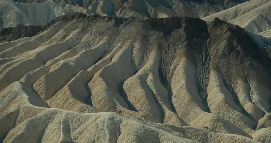 Eroded rock formations in light and dark tones in the desert