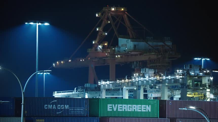 A lit cargo container port at night