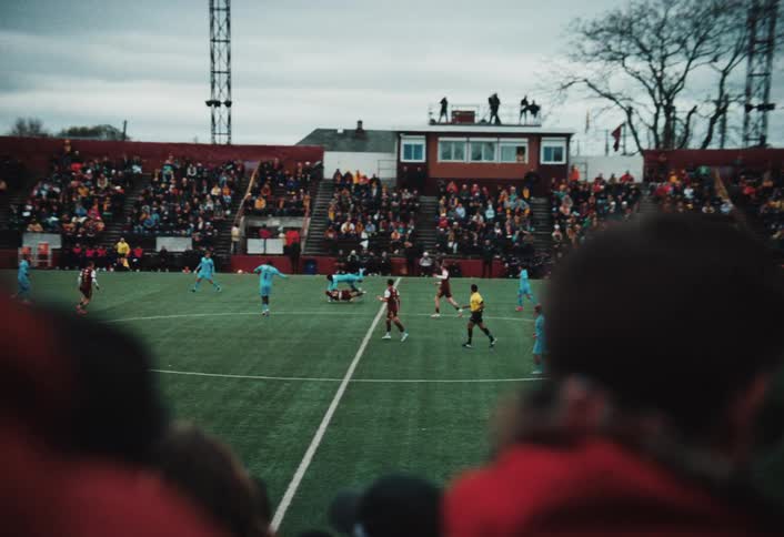 Fans watch the soccer players compete