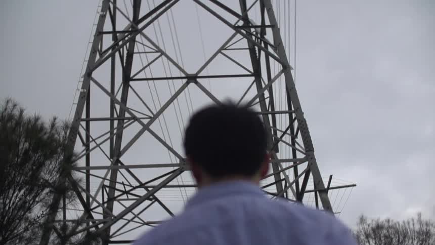 Power line towering over a man