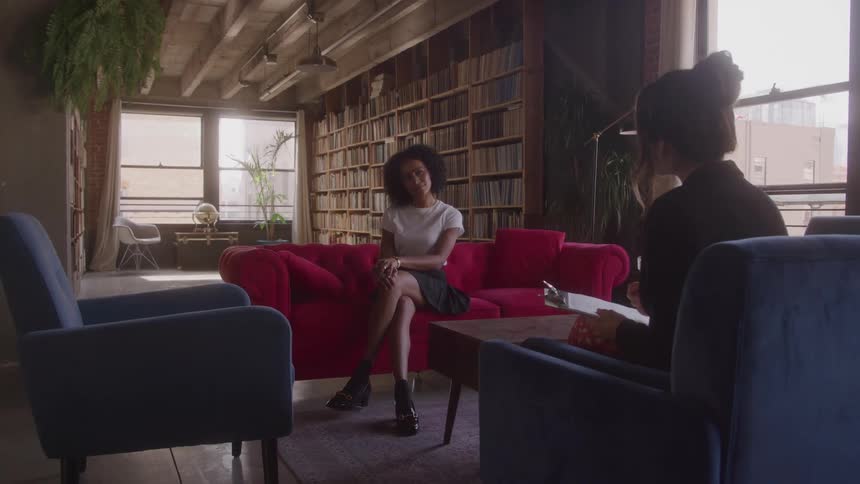 Two women sit and talk