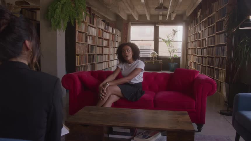 Two women talk in the library