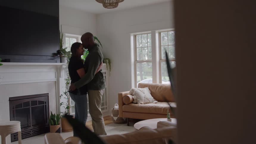 Husband and wife dancing in front of the chimney