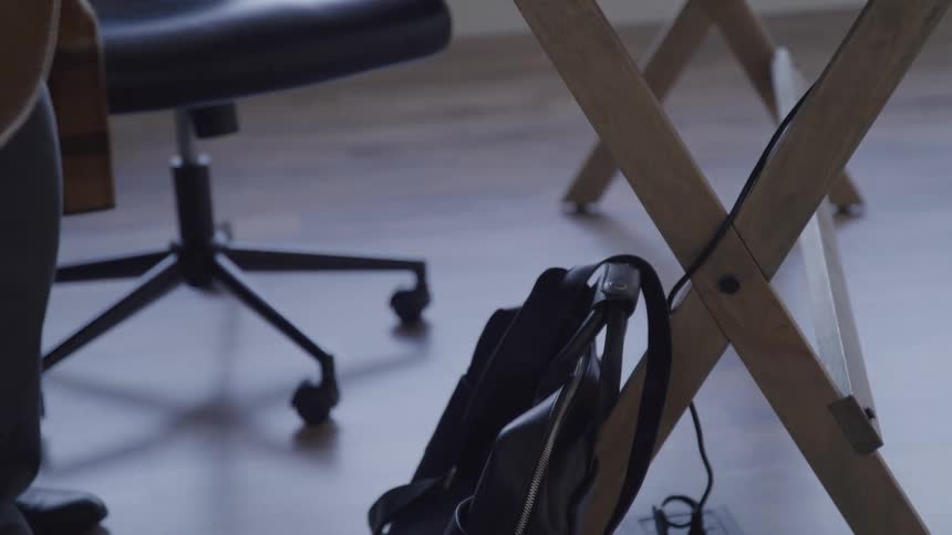 The man picks up his bag and leaves the office