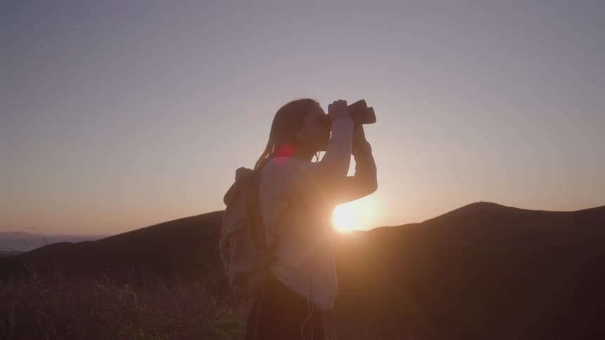 A woman using binoculars