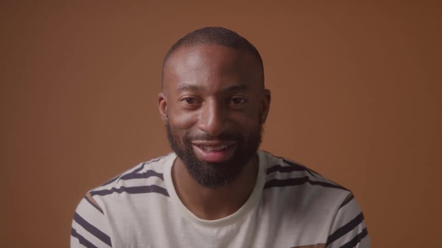A man smiles at the camera