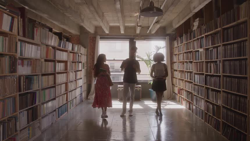 Friends talk while walking in the library