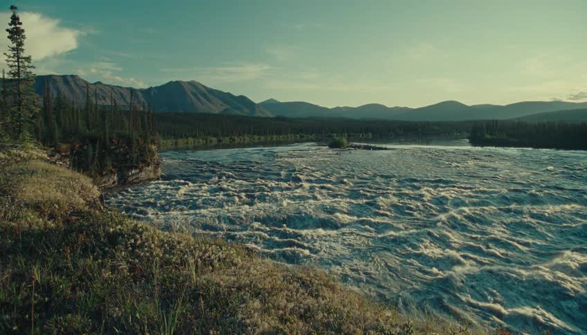 The water in a river flows from the background to the foreground