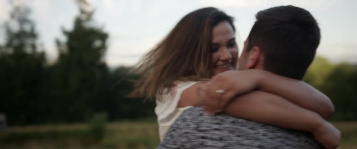 A woman jumps into a man's arms