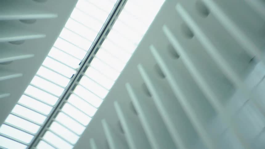 A modern white building interior with skylights and beams