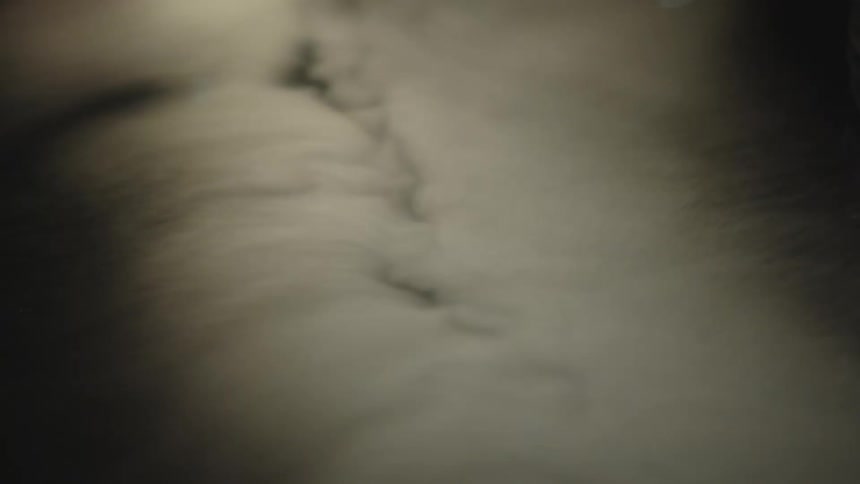 White smoke spreading gently over a dark surface