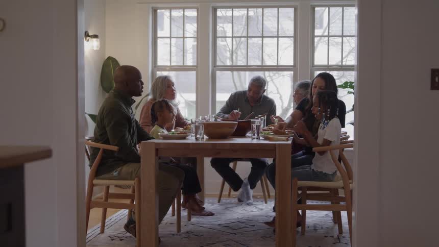 Family gathered around the table sharing a meal