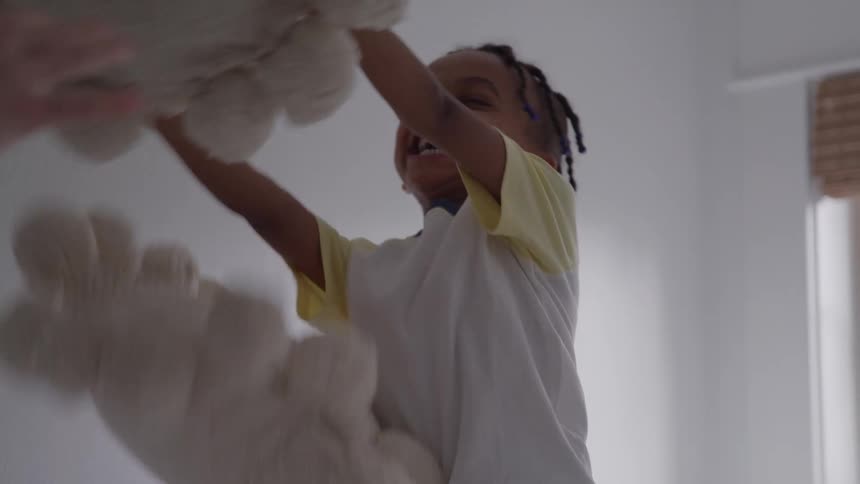 Smiling child playing with a large stuffed bear