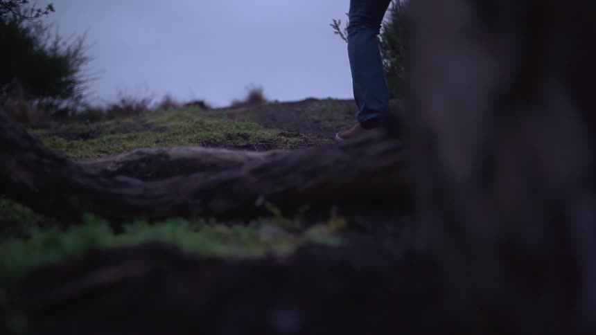 Person standing on a field walking forward