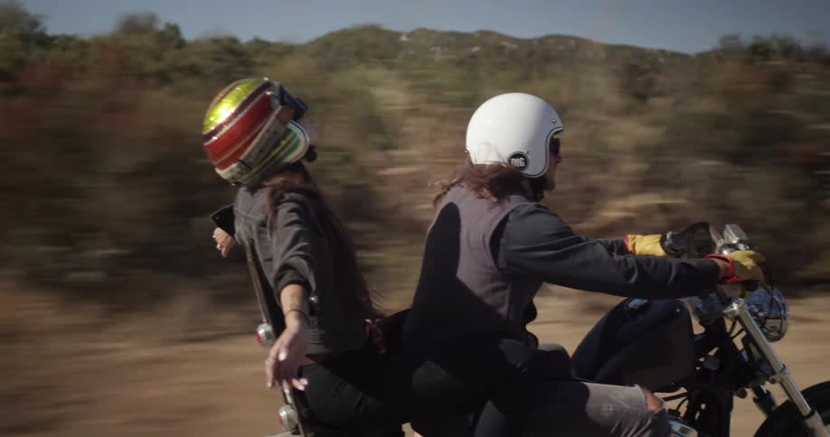Two people ride on a motorcycle together