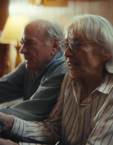 The man and woman are concentrating while playing video games