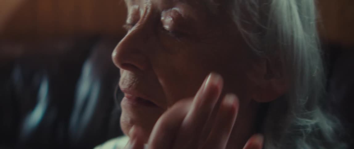 The woman is crying and wipes her nose