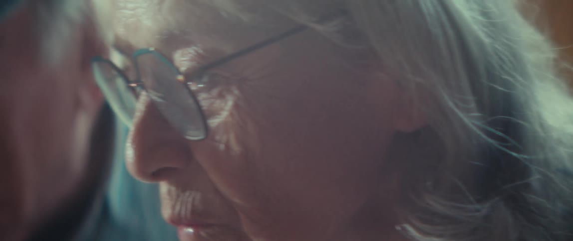 Elderly couple smiling together in a moment of closeness