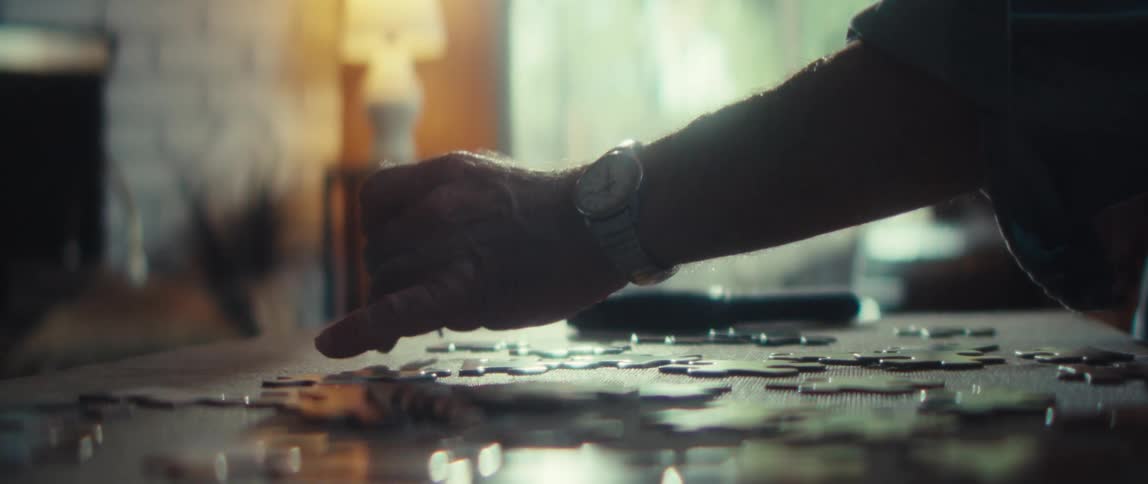 A man does a jigsaw puzzle