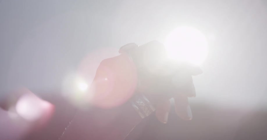 Lens flares behind a hand