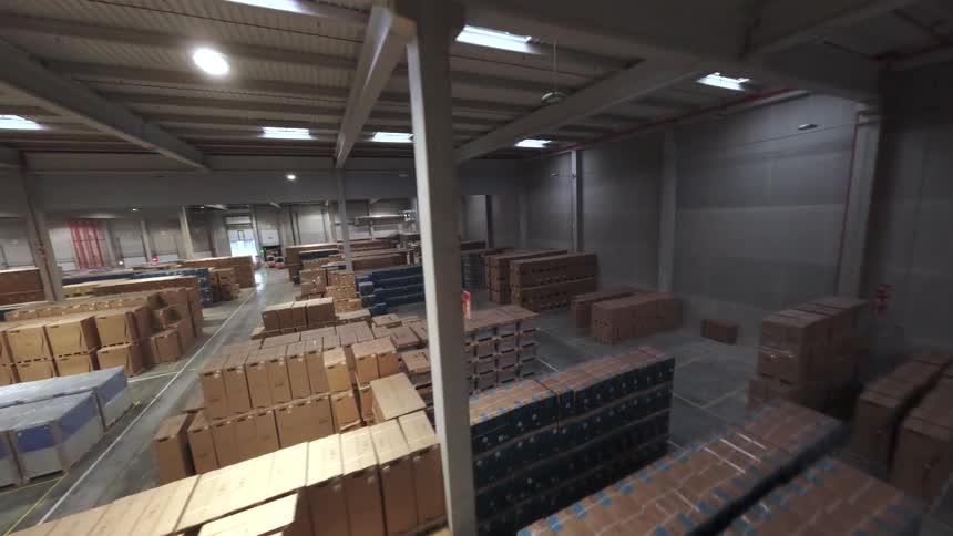 Spacious warehouse interior with large stacks of boxes organized in designated areas