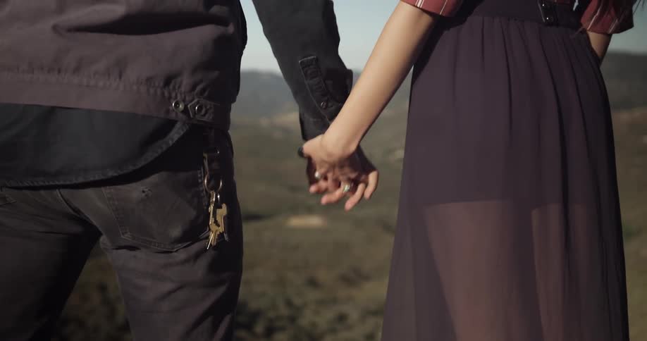 Couple holding hands in scenic area