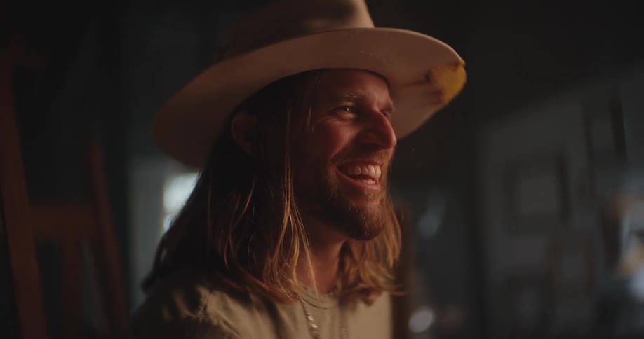 A man laughing at something or someone