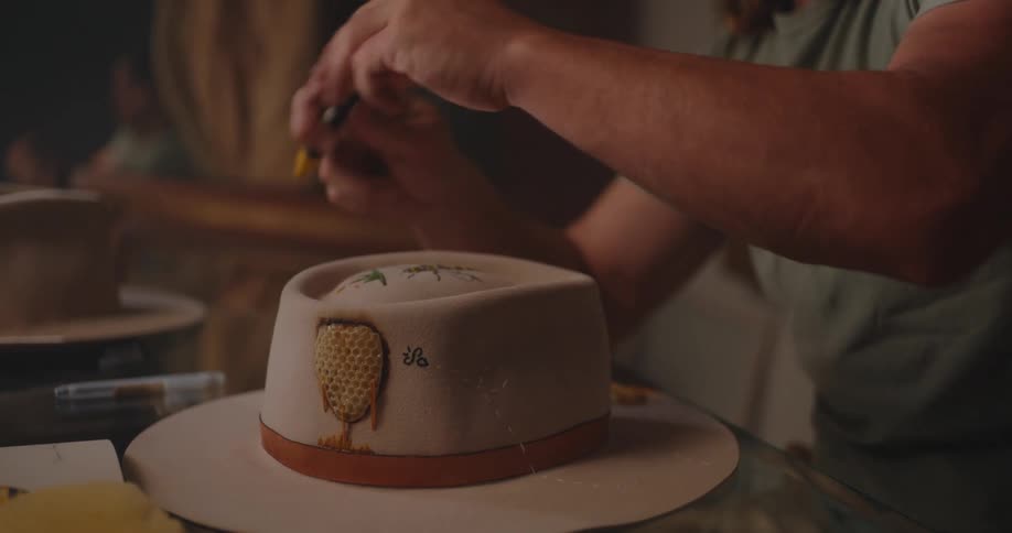 The man draws on the hat