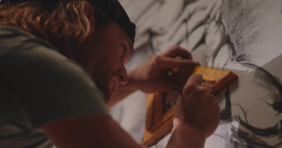 Artist using a triangle ruler on a drawing