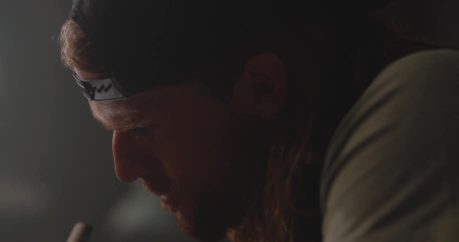 A man writes on a hat