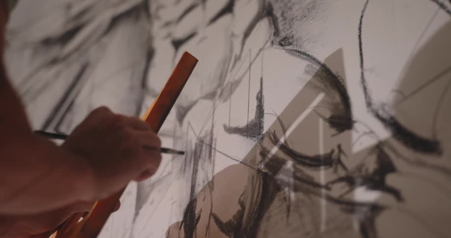 Hands using a wooden set square to draw precise lines over a sketch