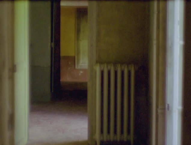 A doorway in a house is shown by a radiator