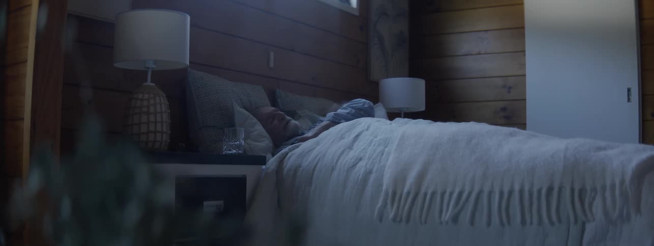 The man is sleeping in the bed