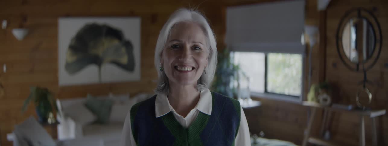 The woman is smiling at home
