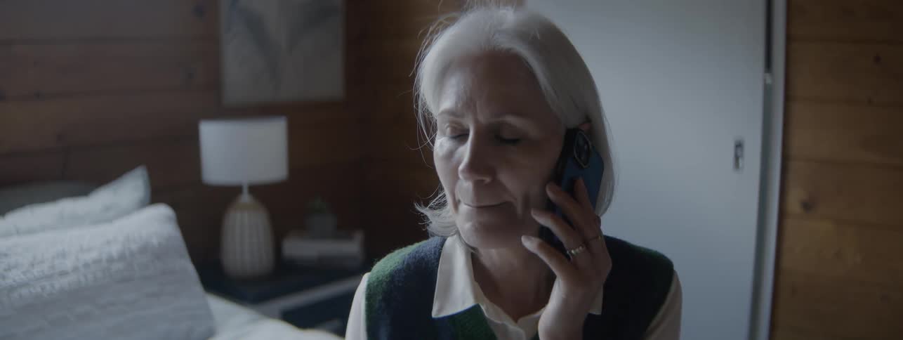 Elderly woman having a phone consultation with a doctor