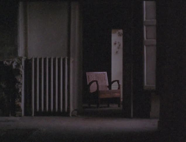 An old radiator and chair inside a house