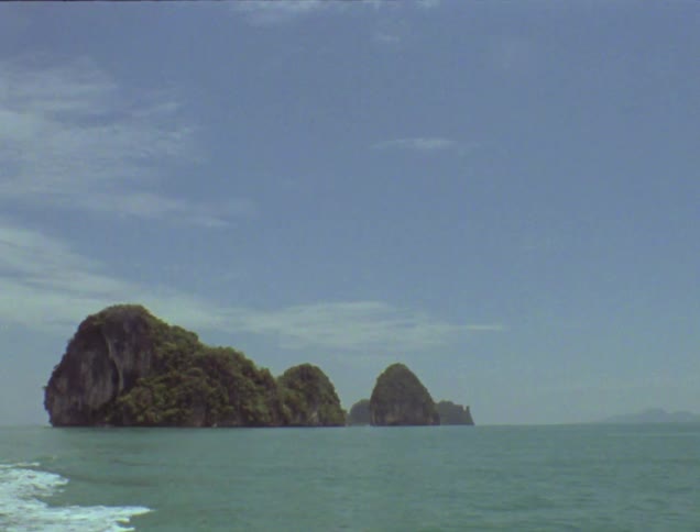 Large rock formation juts out in a body of water