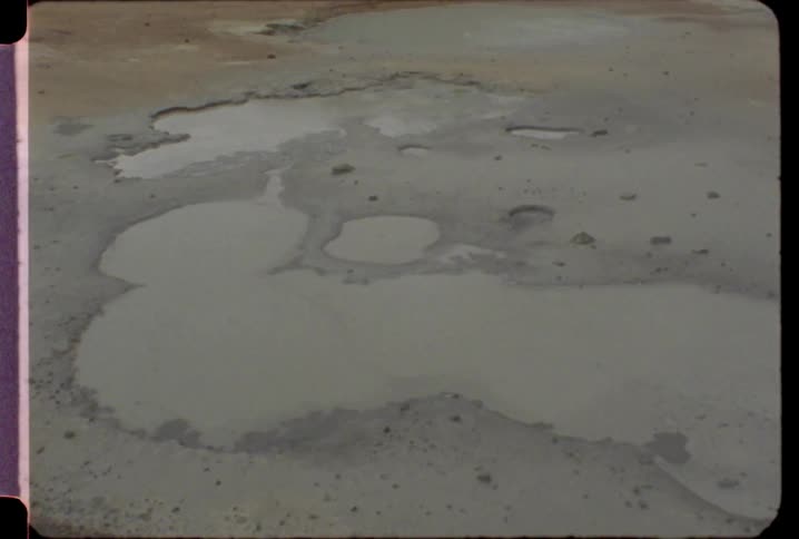 Puddles of water cover the muddy ground