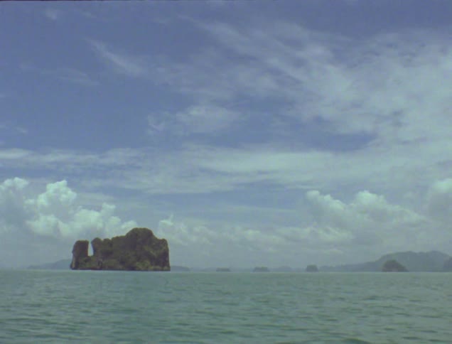 Large rock formation juts out in a body of water