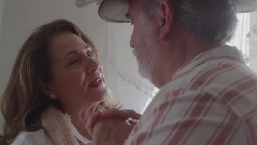 Mature couple sharing affectionate looks while dancing together