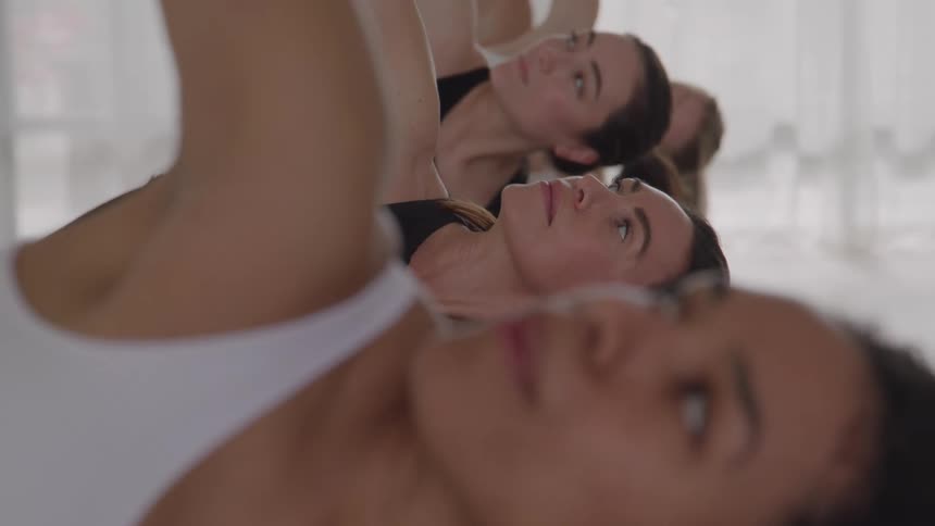 Group remains lying down looking upward during a yoga practice