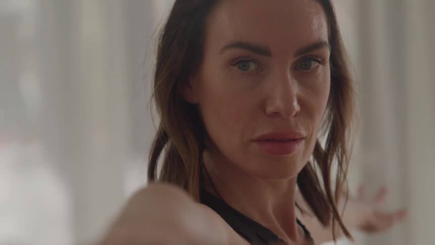 Woman keeps her arms extended forward and looks straight ahead