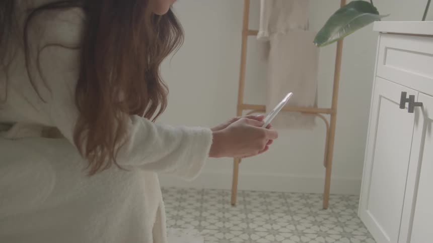 Woman looks at a pregnancy test result in a home setting