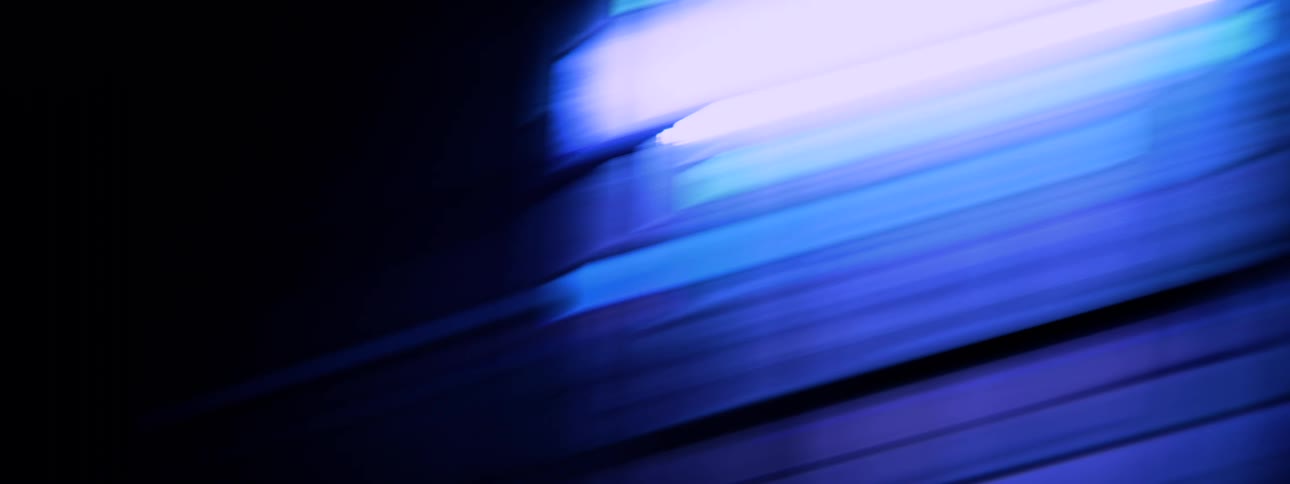 A chaotic scene in which the camera whips side near blue lighting