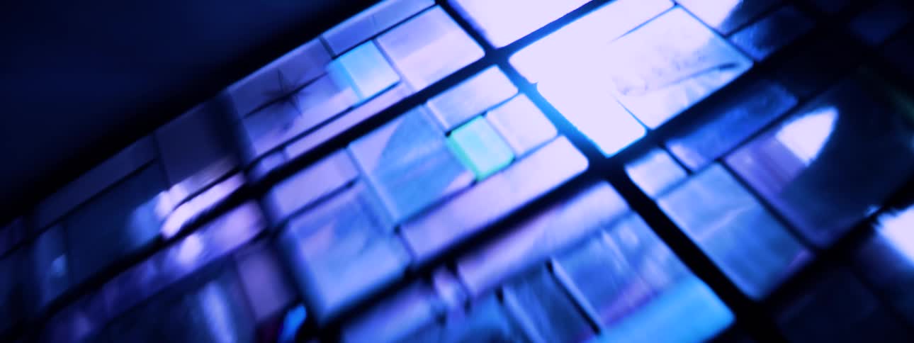 Blue and violet light streaks blur into an abstract arc suggesting motion and electric intensity