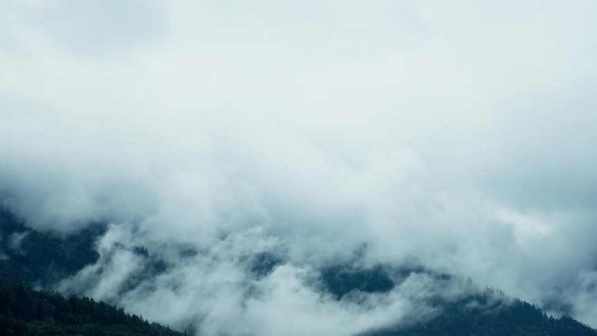 Thick fog covers the mountain tops on a cloudy day