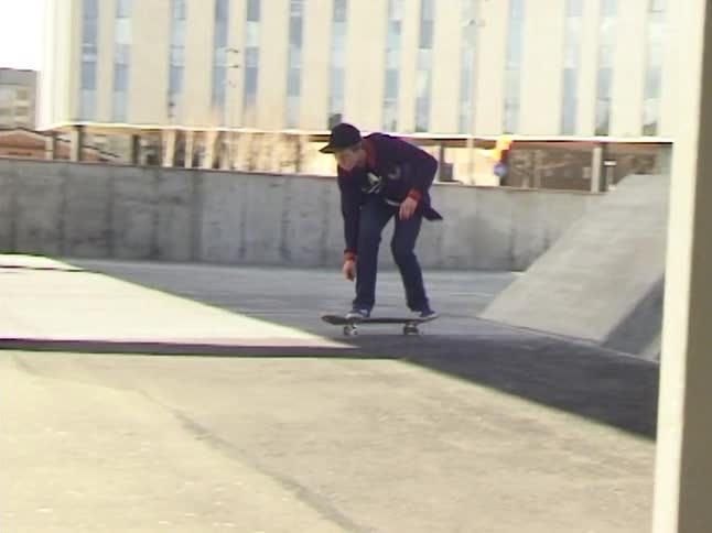 A Skateboarder doing a trick on a concrete structure